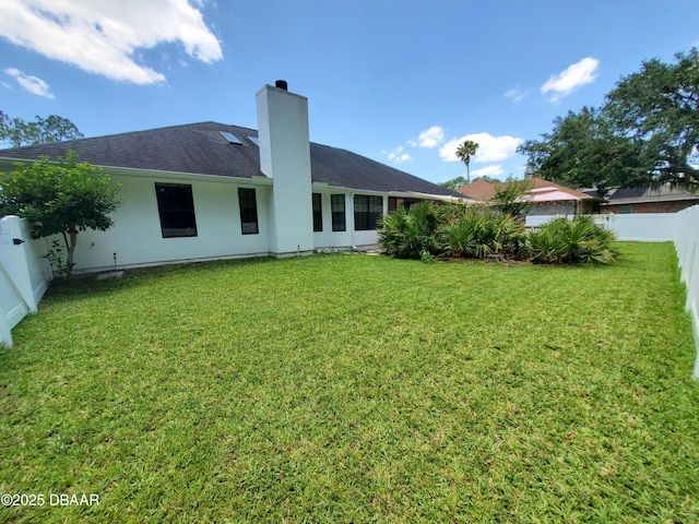 1941 Spruce Creek Lndg, Port Orange, FL 32128 - rear view of property featuring a fenced backyard, a chimney, and stucco siding