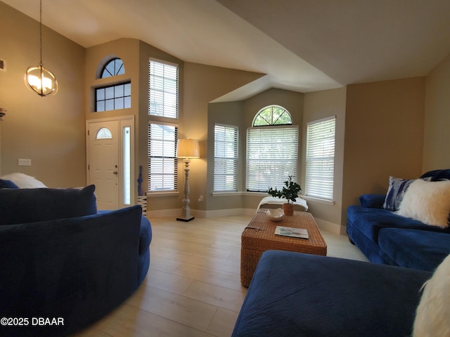 1941 Spruce Creek Lndg, Port Orange, FL 32128 - living room with vaulted ceiling and light wood-style flooring