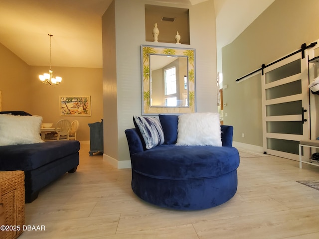 1941 Spruce Creek Lndg, Port Orange, FL 32128 - living area featuring a barn door, high vaulted ceiling, wood finished floors, and a chandelier