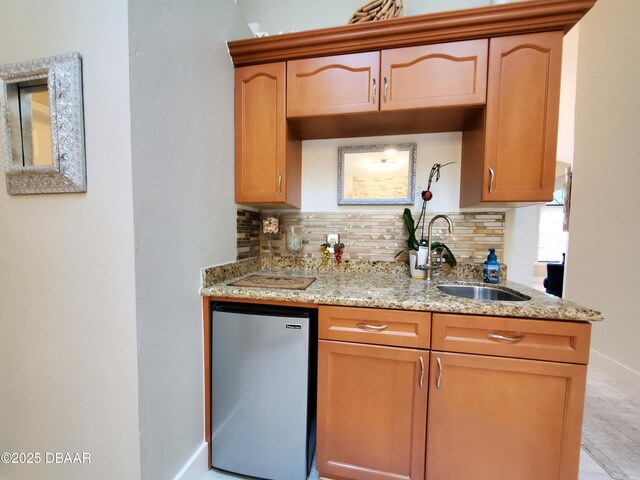 1941 Spruce Creek Lndg, Port Orange, FL 32128 - kitchen featuring refrigerator, decorative backsplash, and light stone countertops