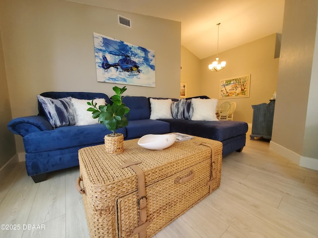 1941 Spruce Creek Lndg, Port Orange, FL 32128 - living room featuring a chandelier, lofted ceiling, and light wood-type flooring