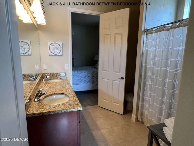 bathroom featuring toilet, vanity, walk in shower, and tile patterned flooring