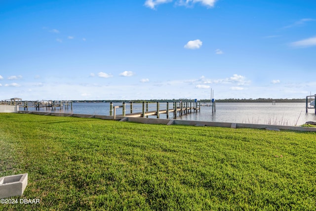 dock area with a yard and a water view