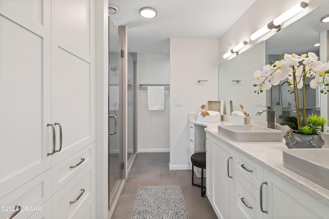 bathroom with vanity and a shower with shower door