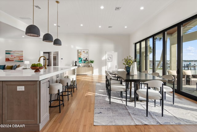 dining space with wooden ceiling, plenty of natural light, and light hardwood / wood-style floors