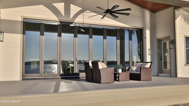 view of patio with ceiling fan and a water view