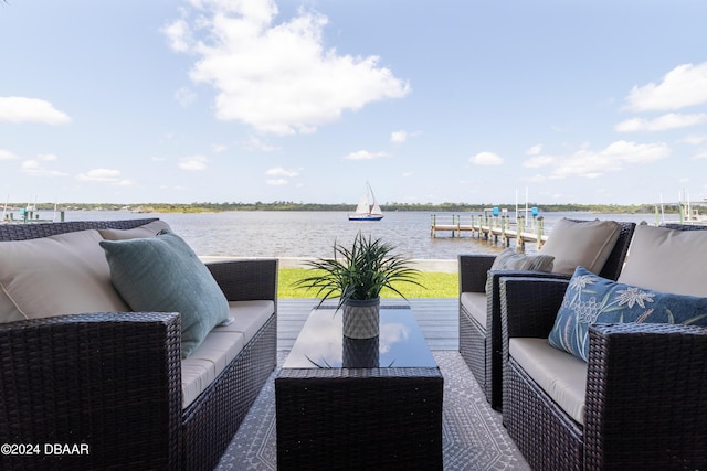 wooden terrace with an outdoor living space, a water view, and a dock