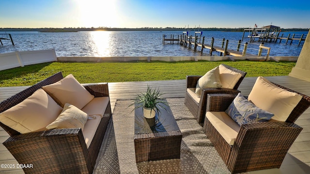 view of dock with a yard and a water view