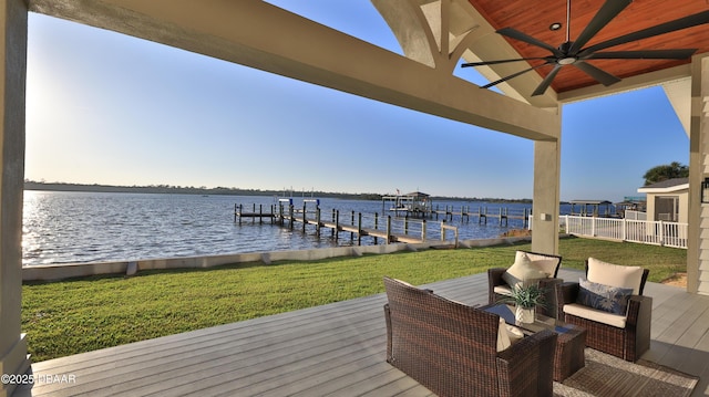 view of dock with a water view and a yard