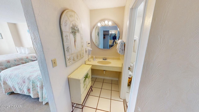 ensuite bathroom with tile patterned flooring, vanity, and ensuite bathroom