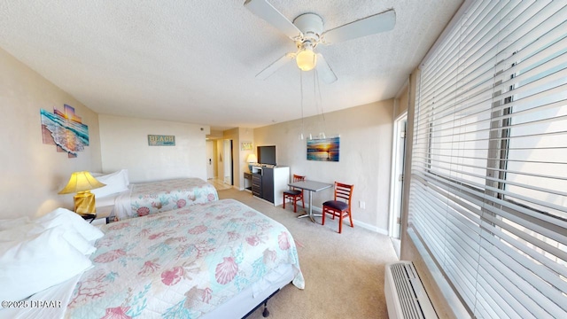 bedroom featuring baseboards, light colored carpet, a textured ceiling, and ceiling fan