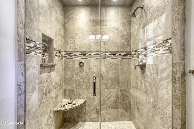 bathroom featuring a shower with door