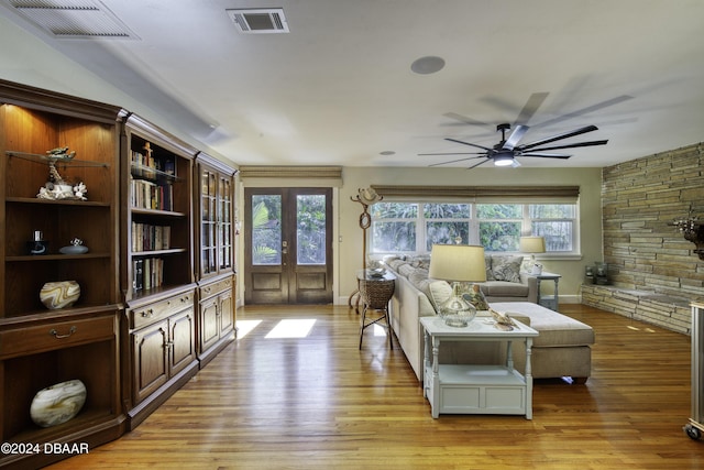 living room with ceiling fan, light hardwood / wood-style flooring, and french doors