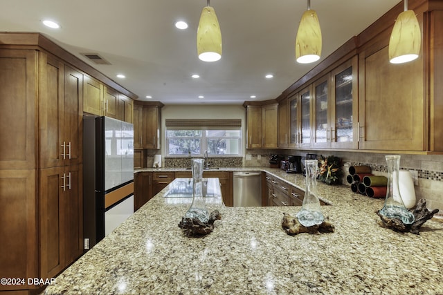 kitchen with dishwasher, backsplash, decorative light fixtures, and light stone countertops