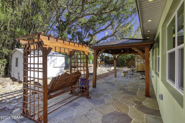 view of patio / terrace with a gazebo and a shed