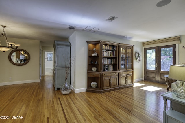 unfurnished room with hardwood / wood-style floors and french doors