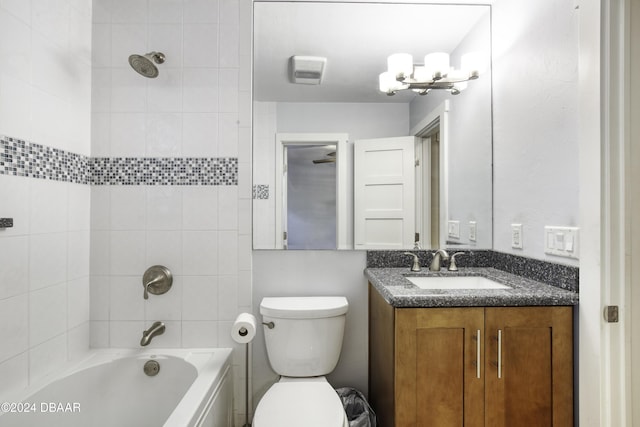 full bathroom with vanity, an inviting chandelier, toilet, and tiled shower / bath