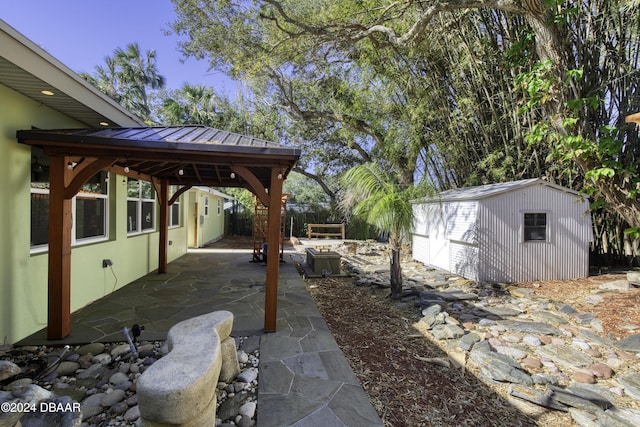 view of patio featuring a gazebo and a storage shed