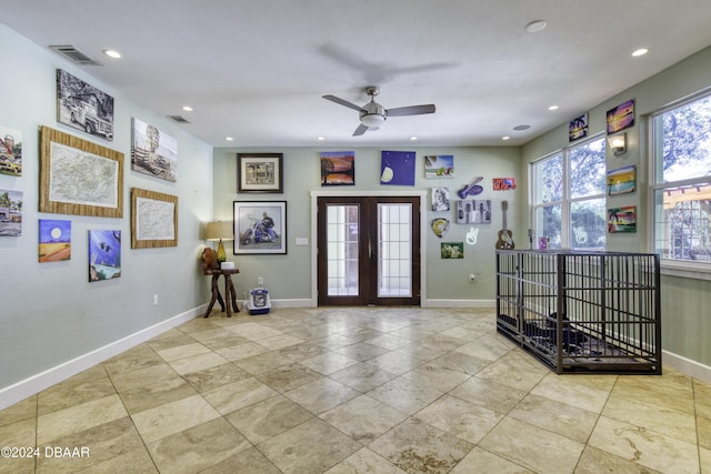 interior space with ceiling fan and french doors