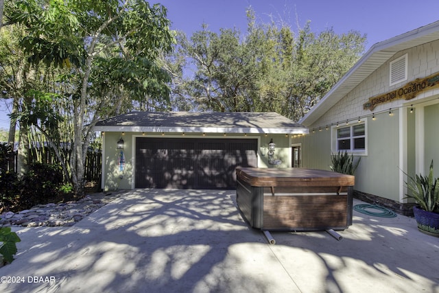 view of patio / terrace with an outdoor structure and a garage