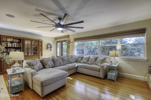 living room featuring ceiling fan and light hardwood / wood-style floors