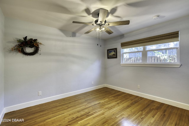 empty room with ceiling fan and hardwood / wood-style floors