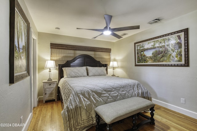 bedroom with light hardwood / wood-style flooring and ceiling fan