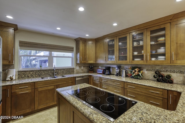 kitchen with sink, dishwasher, light stone counters, backsplash, and black electric cooktop