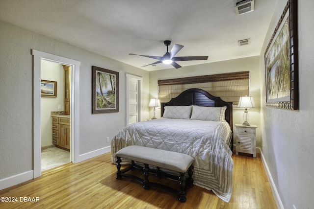 bedroom with ensuite bathroom, ceiling fan, and light hardwood / wood-style floors