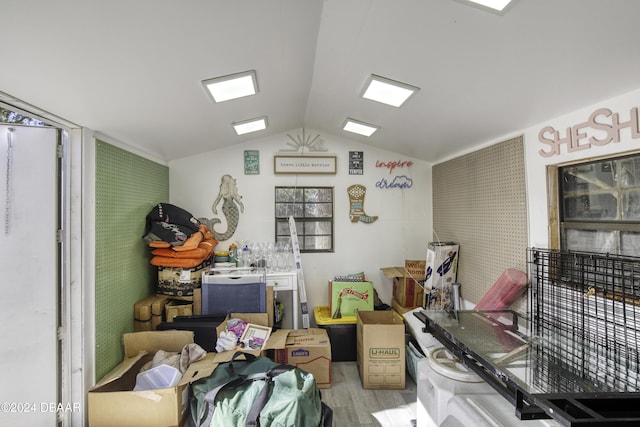 miscellaneous room featuring light hardwood / wood-style floors and vaulted ceiling