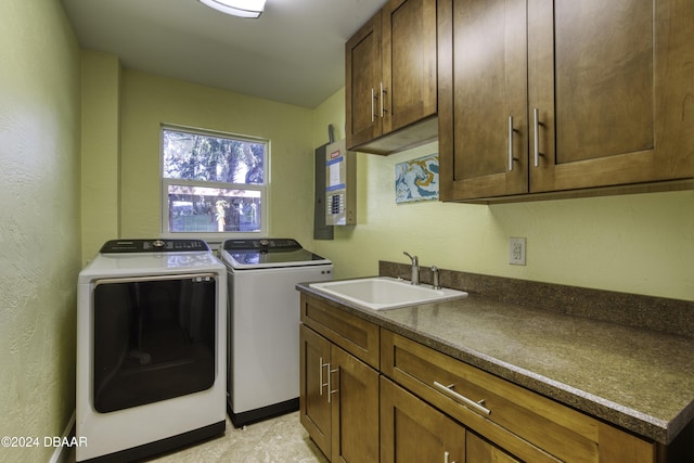 clothes washing area with cabinets, separate washer and dryer, sink, and electric panel