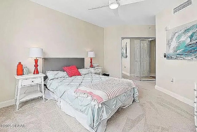 carpeted bedroom with a ceiling fan, baseboards, visible vents, and a closet