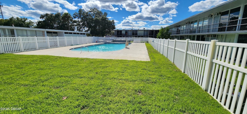 view of pool featuring a yard and a patio