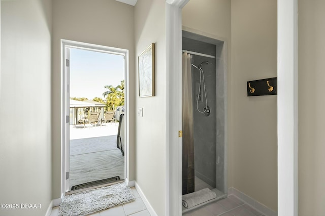 interior space with tile patterned flooring and walk in shower