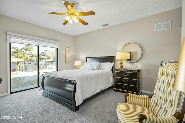 carpeted bedroom with access to exterior, a textured ceiling, and ceiling fan