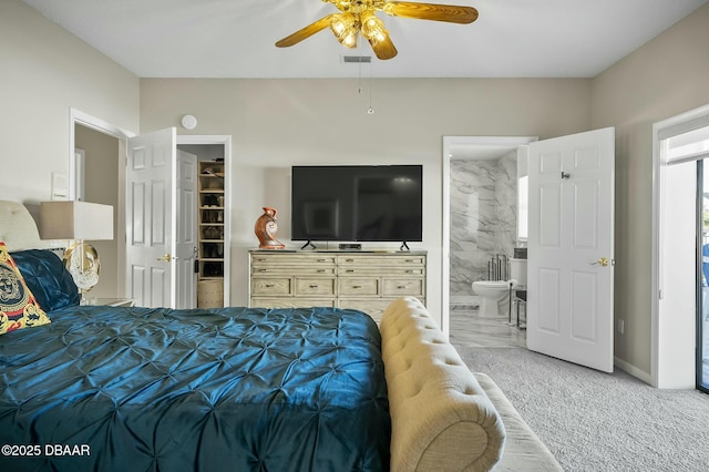 bedroom featuring ceiling fan, carpet floors, and ensuite bath