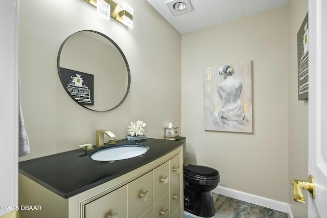 bathroom featuring a textured ceiling, vanity, toilet, and wood-type flooring