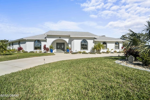 mediterranean / spanish-style house featuring a front yard