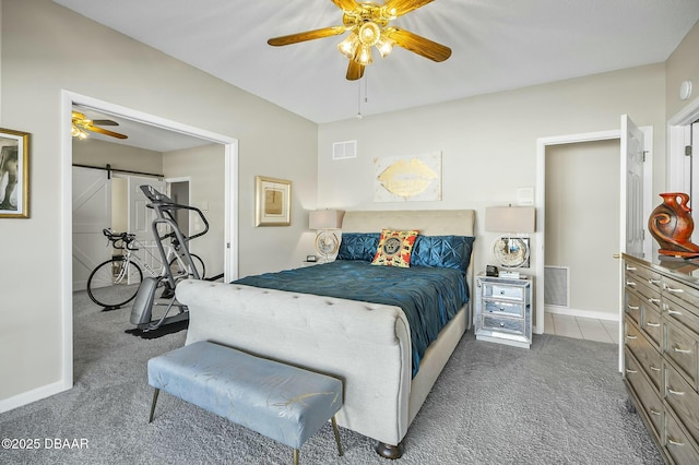 bedroom featuring carpet flooring, ceiling fan, and a barn door