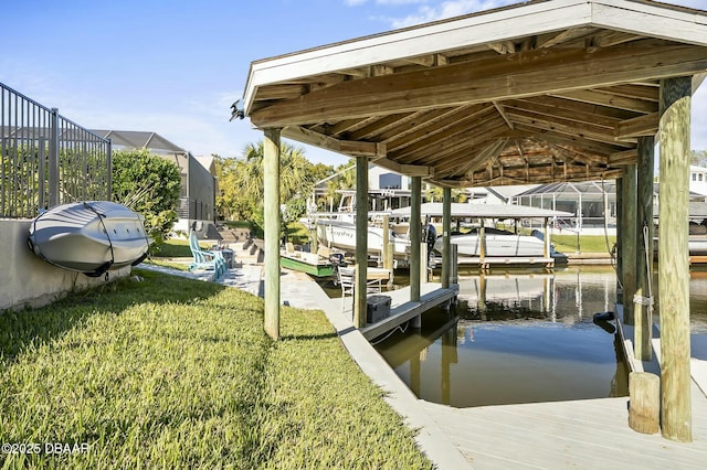 dock area with a water view, a lanai, and a lawn