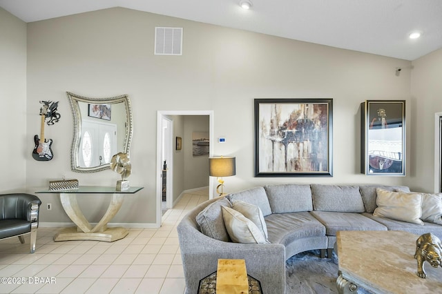 living room with light tile patterned floors and vaulted ceiling