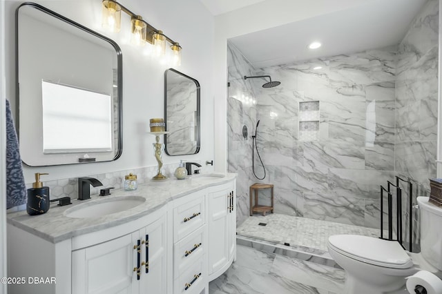 bathroom featuring toilet, vanity, and tiled shower