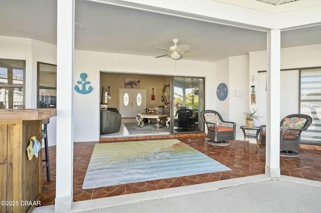 interior space with ceiling fan