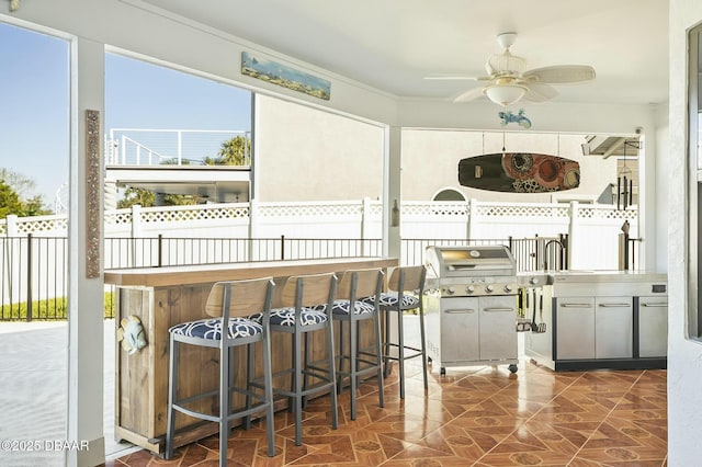 kitchen featuring dark tile patterned flooring and ceiling fan