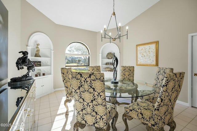 tiled dining space featuring a notable chandelier and lofted ceiling