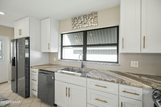 kitchen featuring light stone countertops, stainless steel fridge, sink, dishwasher, and white cabinetry