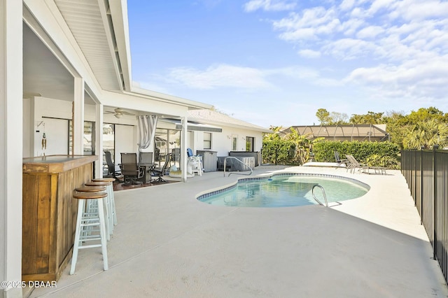 view of pool with a patio area and an outdoor bar