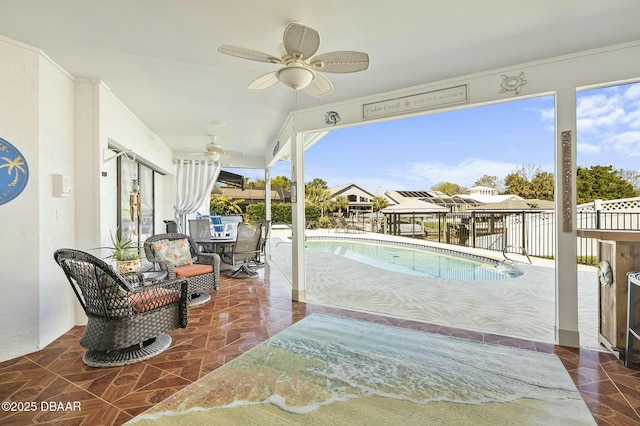 view of swimming pool with ceiling fan and a patio