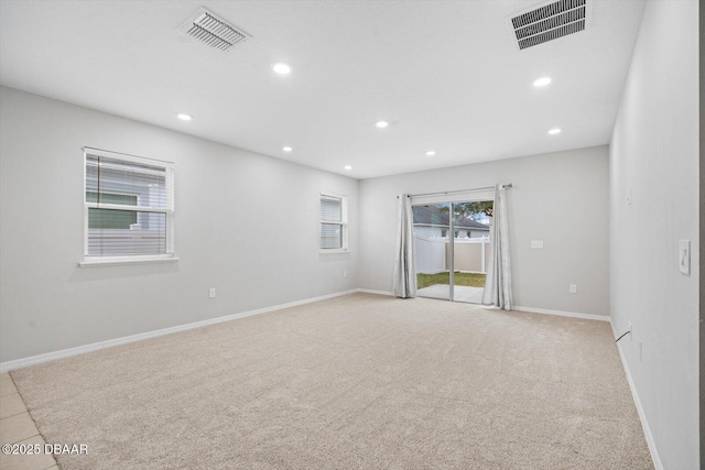 empty room featuring light carpet