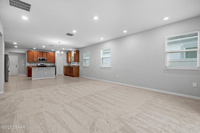 unfurnished living room featuring light colored carpet